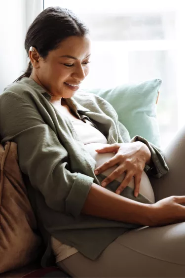pregnant-woman-sitting-on-windowsill