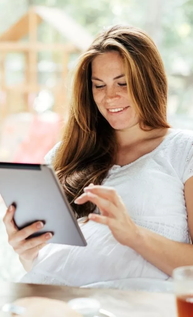 Pregnant mother reading on ipad