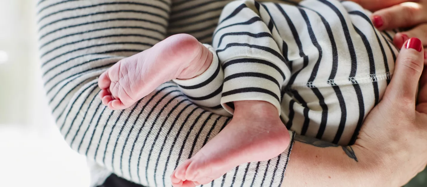 babys-feet-dangle-over-moms-arms