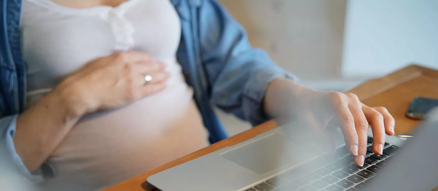 Pregnant mother on laptop