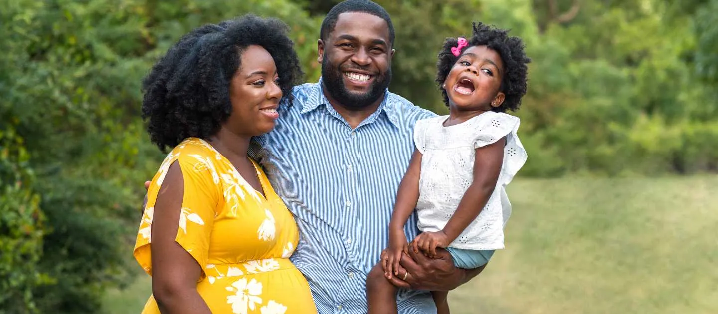 Happy young family laughing at daughter
