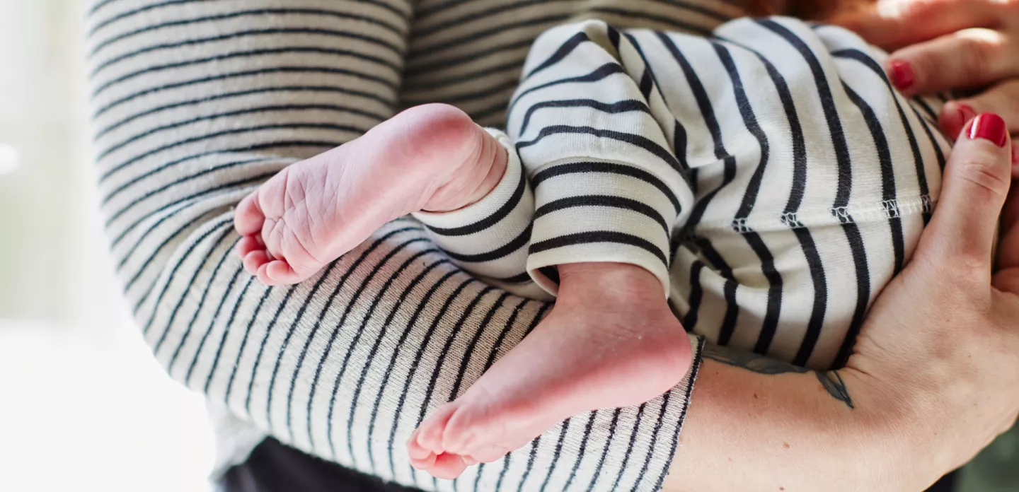 babys-feet-dangle-over-moms-arms